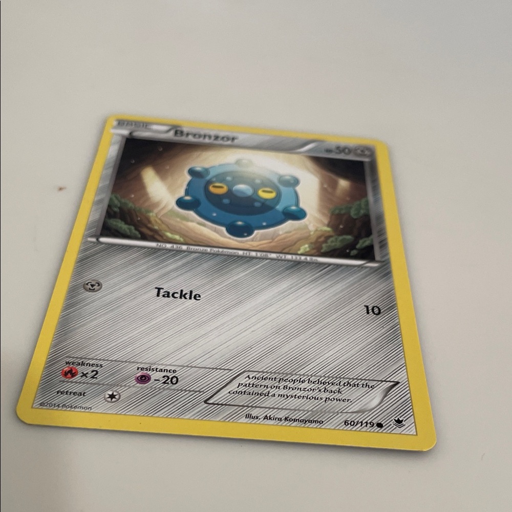 Pokemon Bronzor Trading Card with Yellow Border